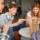 The company of young people plays a table game called jenga.